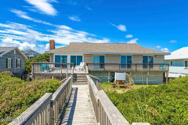 6301 Ocean Dr, Emerald Isle, NC 28594 - back of property with a deck and a chimney