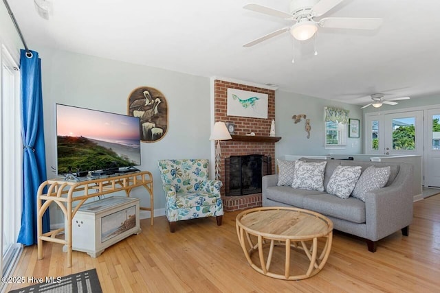 6301 Ocean Dr, Emerald Isle, NC 28594 - living room with wood finished floors, ceiling fan, a brick fireplace, and baseboards