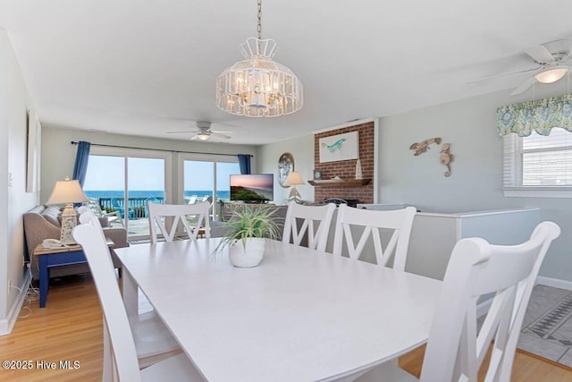 6301 Ocean Dr, Emerald Isle, NC 28594 - dining room featuring ceiling fan, a chandelier, plenty of natural light, and light wood-type flooring