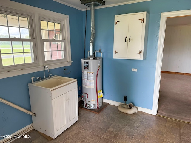 utility room with gas water heater and a sink