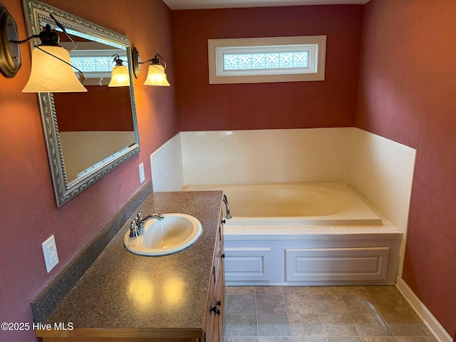 full bath featuring a garden tub and vanity