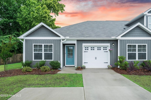 ranch-style house featuring an attached garage, concrete driveway, board and batten siding, and a shingled roof