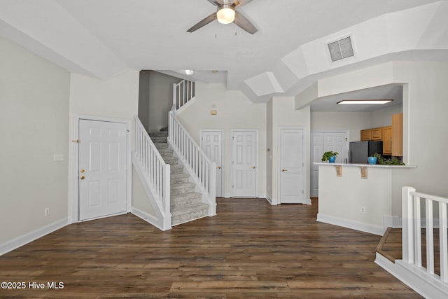 entrance foyer with stairway, a ceiling fan, baseboards, and dark wood-style flooring