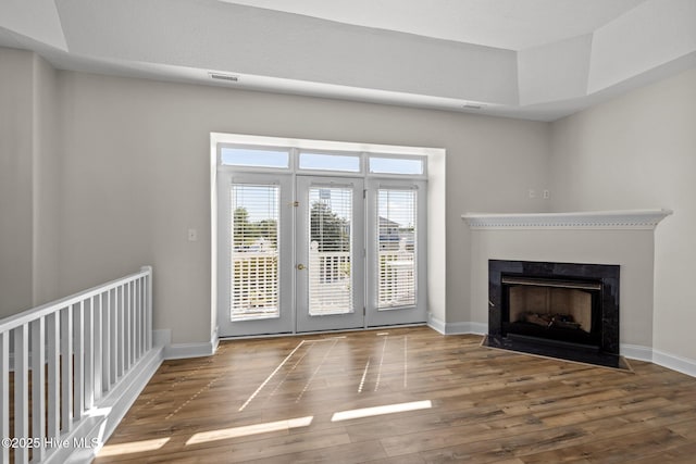 entryway featuring wood finished floors, baseboards, and french doors