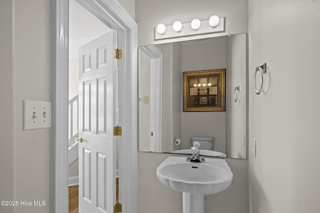 bathroom with a sink and wood finished floors