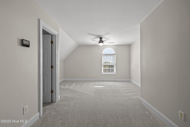 bonus room with carpet flooring, ceiling fan, vaulted ceiling, and baseboards
