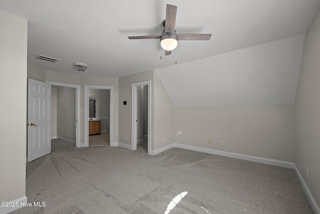 bonus room with carpet flooring, ceiling fan, baseboards, and lofted ceiling