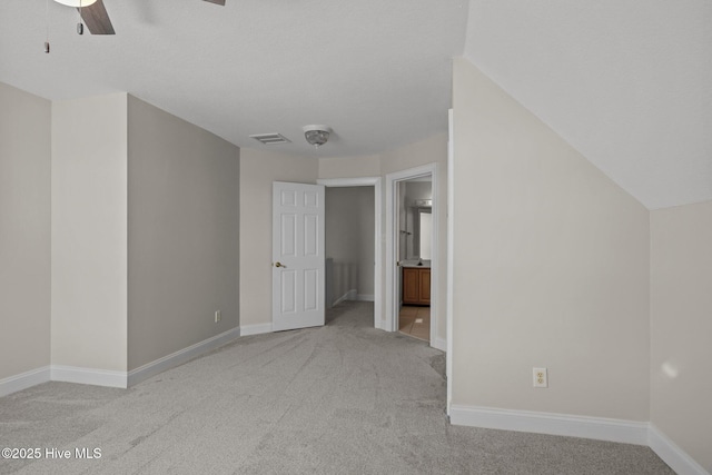 unfurnished bedroom with light colored carpet, baseboards, and ceiling fan