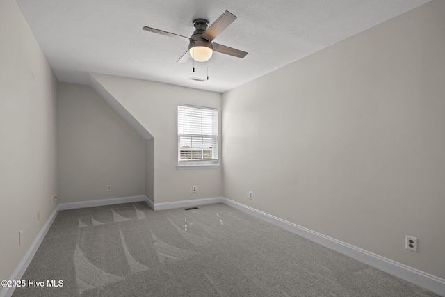unfurnished room with light carpet, a ceiling fan, and baseboards