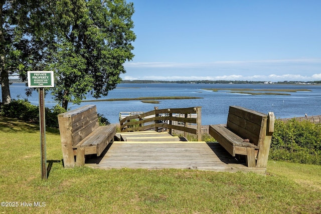 view of community with a water view and a yard