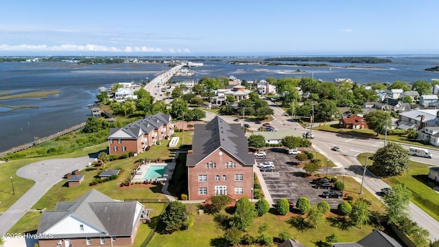 aerial perspective of suburban area featuring a nearby body of water and a notable bridge
