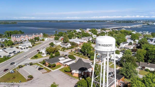 aerial perspective of suburban area with a nearby body of water