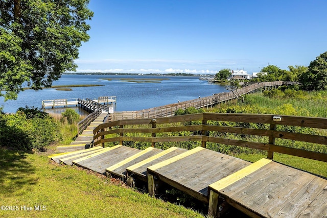 wooden terrace featuring a water view