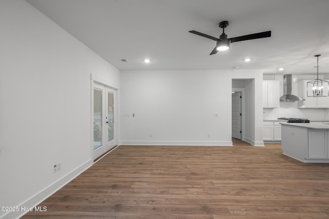 unfurnished living room with recessed lighting, baseboards, a ceiling fan, and wood finished floors
