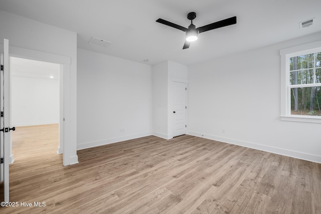 unfurnished bedroom with light wood-type flooring, baseboards, and a ceiling fan