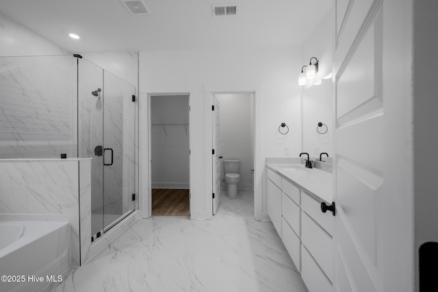 full bath with a marble finish shower, a bath, vanity, marble look tiles, and toilet