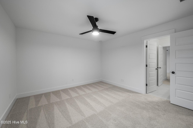 unfurnished bedroom with light carpet, baseboards, and a ceiling fan