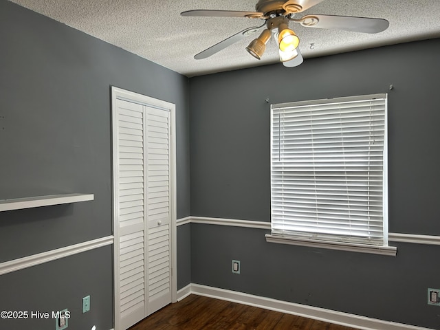 3414 Middle Sound Loop Rd, Wilmington, NC 28411 - unfurnished bedroom featuring a closet, a textured ceiling, wood finished floors, and a ceiling fan