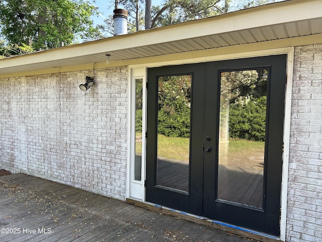 3414 Middle Sound Loop Rd, Wilmington, NC 28411 - property entrance with french doors, brick siding, and a deck