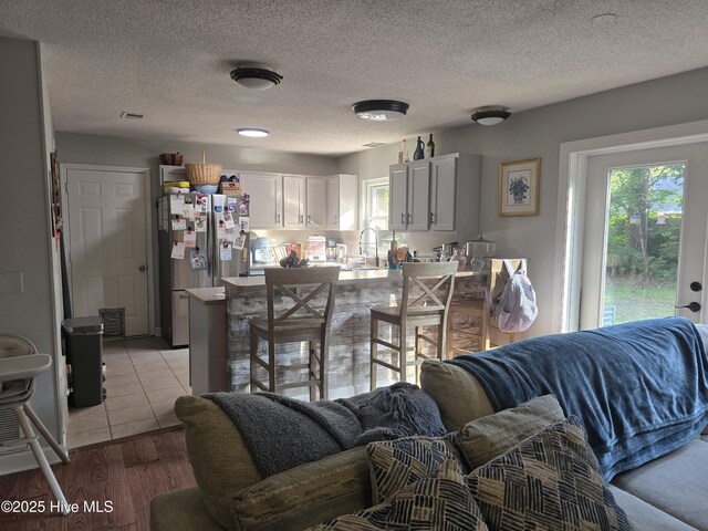 3414 Middle Sound Loop Rd, Wilmington, NC 28411 - kitchen featuring freestanding refrigerator, healthy amount of natural light, a peninsula, and a sink