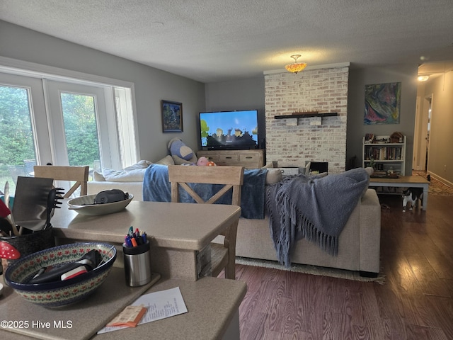 3414 Middle Sound Loop Rd, Wilmington, NC 28411 - living area featuring dark wood finished floors, a textured ceiling, and a fireplace
