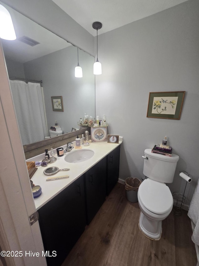 3414 Middle Sound Loop Rd, Wilmington, NC 28411 - bathroom with wood finished floors, vanity, and toilet