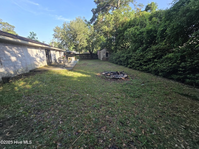 3414 Middle Sound Loop Rd, Wilmington, NC 28411 - view of yard featuring an outdoor fire pit and a patio area