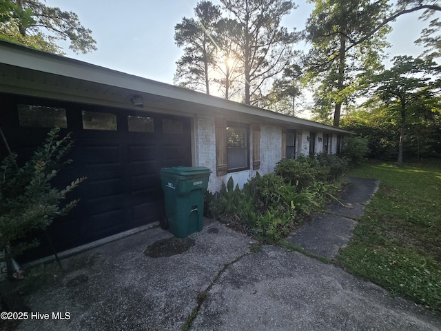 3414 Middle Sound Loop Rd, Wilmington, NC 28411 - view of side of home featuring a garage, brick siding, and driveway