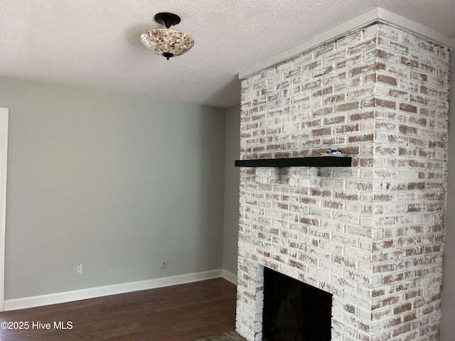 3414 Middle Sound Loop Rd, Wilmington, NC 28411 - detailed view of wood finished floors, baseboards, a textured ceiling, and a brick fireplace