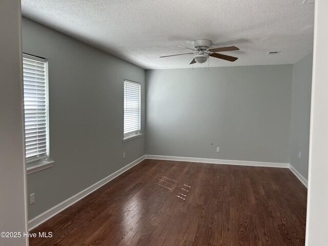 3414 Middle Sound Loop Rd, Wilmington, NC 28411 - spare room with a textured ceiling, a ceiling fan, dark wood-style floors, and baseboards