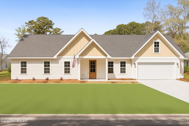 355 S Middleton Dr NW, Calabash, NC 28467 - view of front of home featuring board and batten siding, driveway, a shingled roof, and a front lawn