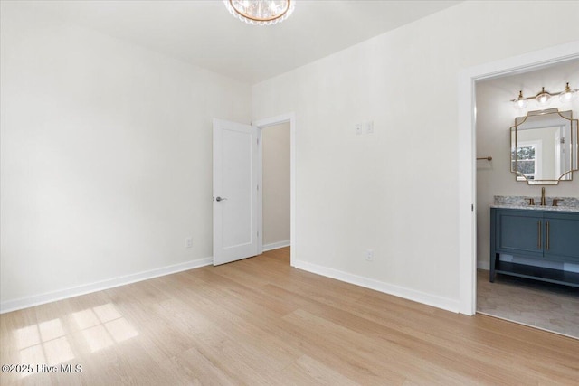 355 S Middleton Dr NW, Calabash, NC 28467 - unfurnished room with a sink, light wood-type flooring, and baseboards