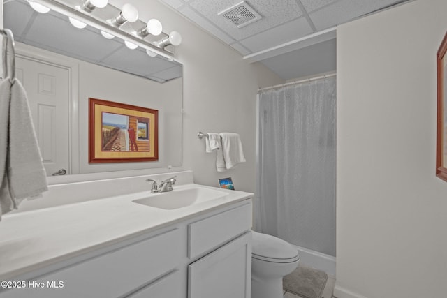 bathroom featuring a paneled ceiling, toilet, vanity, and a shower with curtain