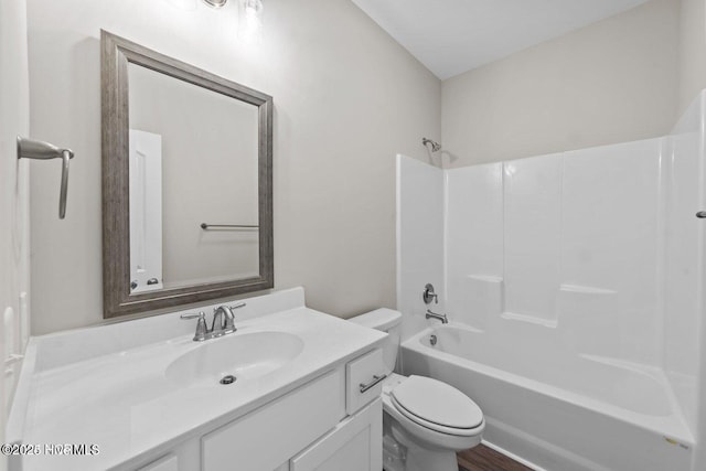 full bath featuring toilet, vanity, and tub / shower combination