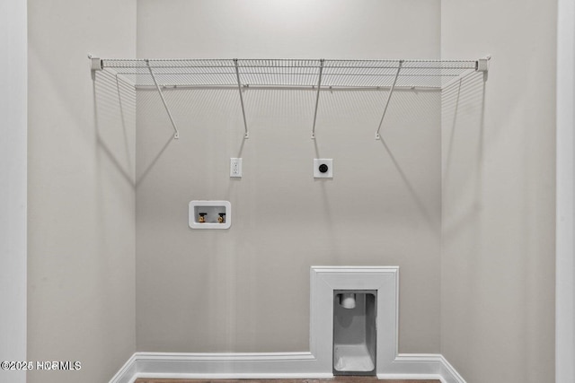 laundry area featuring hookup for a washing machine, electric dryer hookup, and baseboards