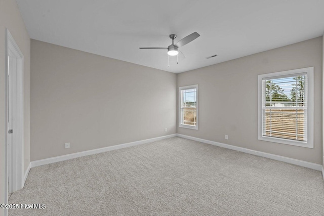unfurnished bedroom featuring carpet floors, multiple windows, and baseboards
