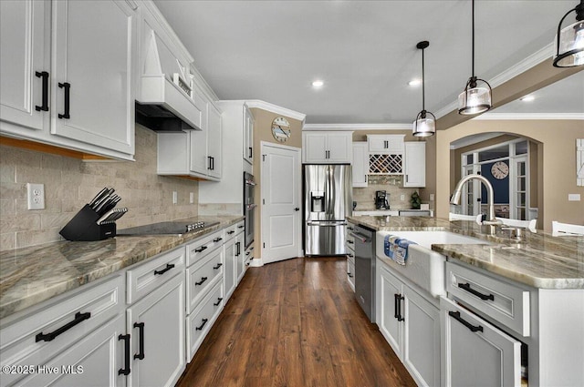 97 Eagle Claw Dr, Calabash, NC 28467 - kitchen with appliances with stainless steel finishes, a sink, white cabinetry, arched walkways, and crown molding