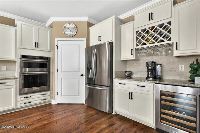 97 Eagle Claw Dr, Calabash, NC 28467 - kitchen with appliances with stainless steel finishes, beverage cooler, light stone counters, dark wood-style floors, and crown molding