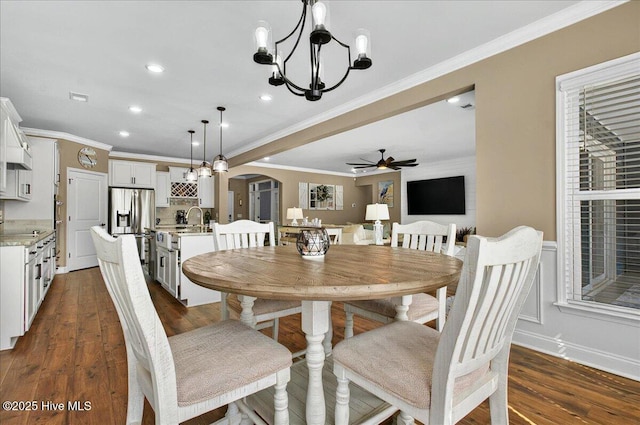 97 Eagle Claw Dr, Calabash, NC 28467 - dining space with arched walkways, a chandelier, crown molding, ceiling fan, and dark wood-style flooring