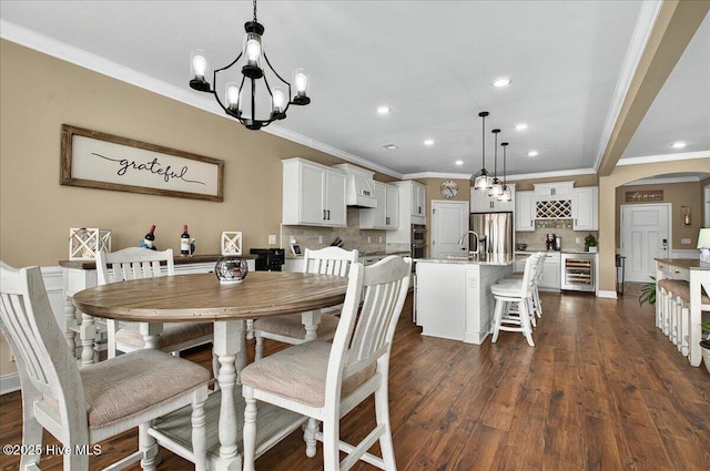 97 Eagle Claw Dr, Calabash, NC 28467 - dining area featuring arched walkways, recessed lighting, ornamental molding, a chandelier, and dark wood-style flooring