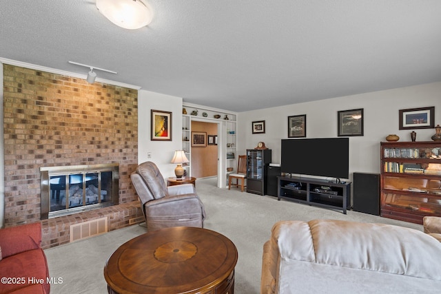 106 Millstone Rd, West End, NC 27376 - carpeted living area with a textured ceiling, a fireplace, and track lighting