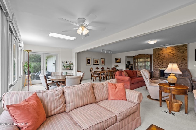106 Millstone Rd, West End, NC 27376 - carpeted living room with ceiling fan and a skylight