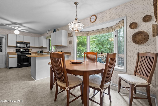 106 Millstone Rd, West End, NC 27376 - dining space featuring wallpapered walls, a chandelier, and a ceiling fan