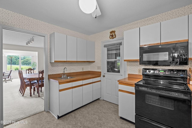 106 Millstone Rd, West End, NC 27376 - kitchen with black appliances, wallpapered walls, a sink, light countertops, and a ceiling fan