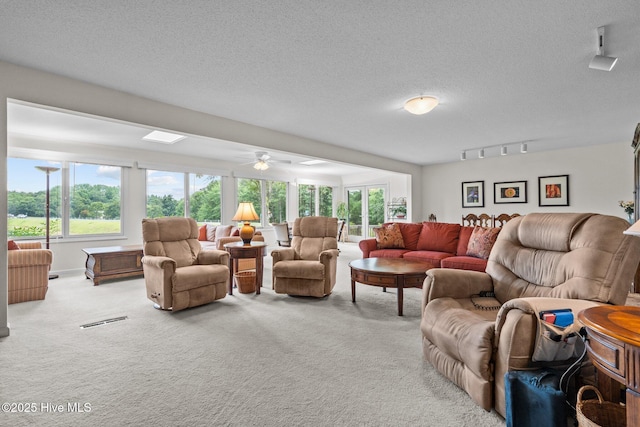 106 Millstone Rd, West End, NC 27376 - carpeted living room with rail lighting, ceiling fan, and a textured ceiling