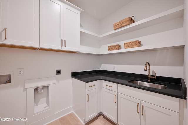 laundry room with electric dryer hookup, light wood-style floors, washer hookup, cabinet space, and bar with sink