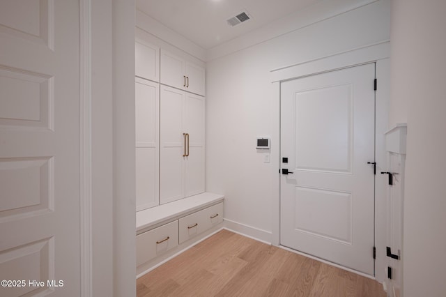mudroom featuring light wood-style floors and baseboards