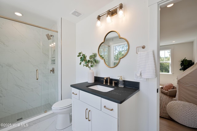 ensuite bathroom with a marble finish shower, toilet, recessed lighting, and vanity