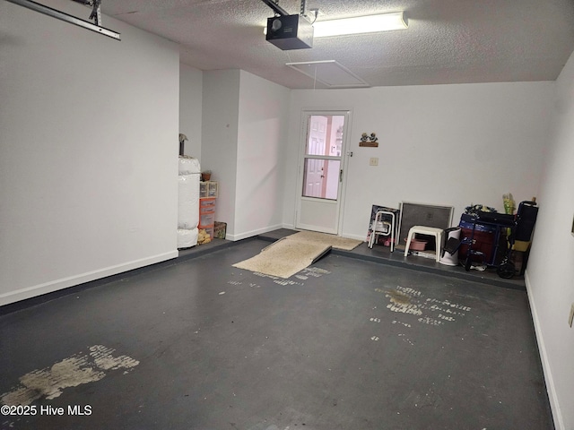 garage featuring a garage door opener, baseboards, and gas water heater