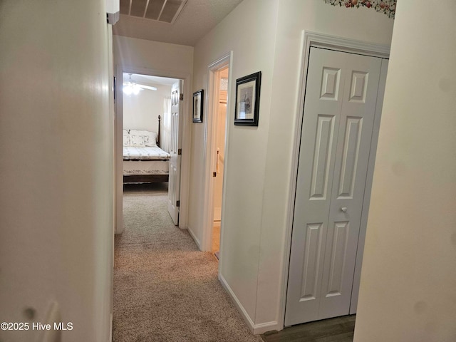 corridor featuring carpet and baseboards